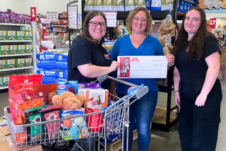 three woman with donation check
