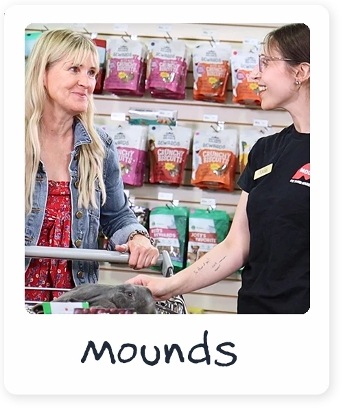 Mounds employee helping woman